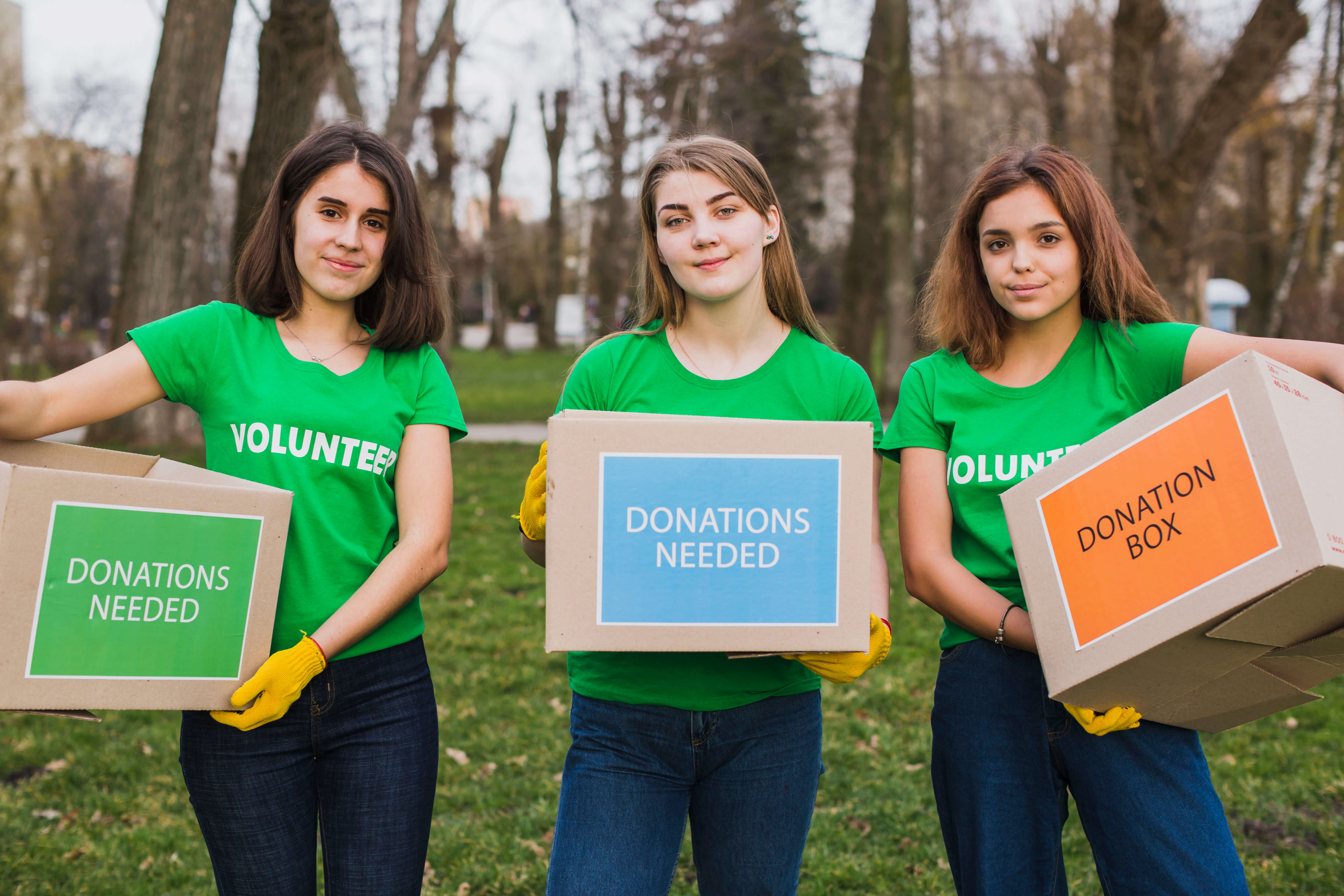 volunteers holding donation boxes